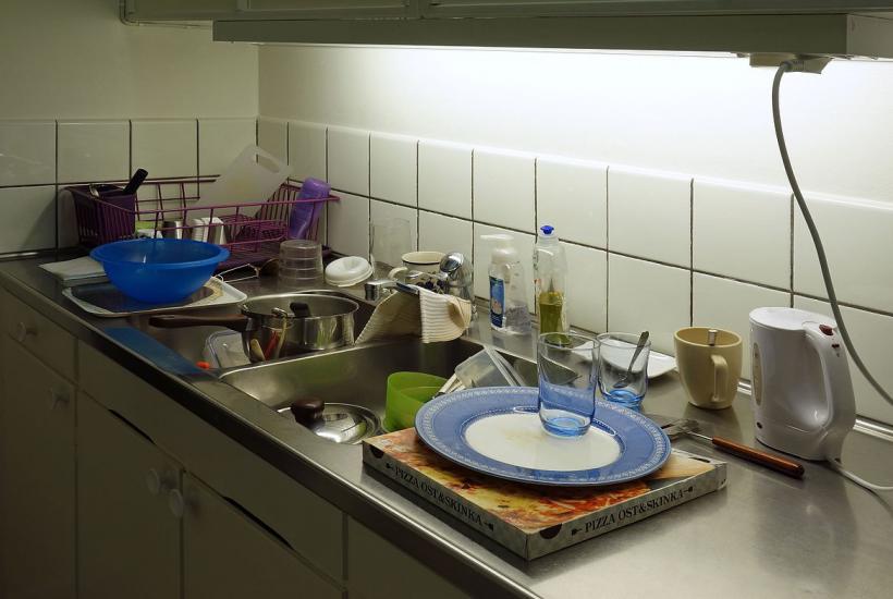 A messy kitchen sink with assorted unwashed items in Lysekil Municipality, Sweden.